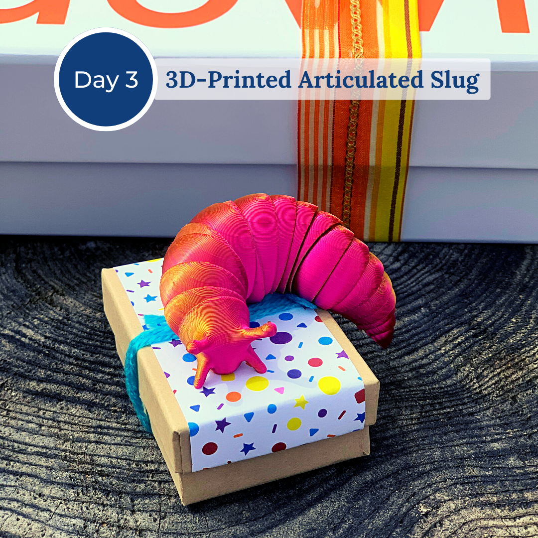 Pink 3d-printed articulated slug on top of a gift box