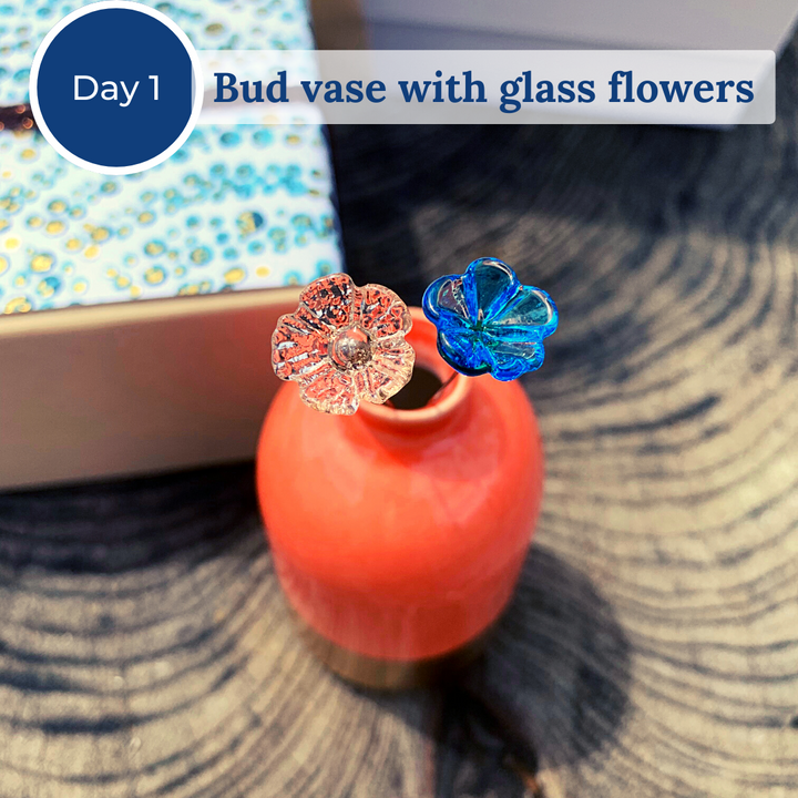 Orange bud vase with two glass flowers