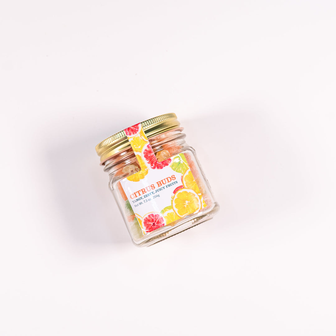 A jar of citrus bud candies, with a colorful label