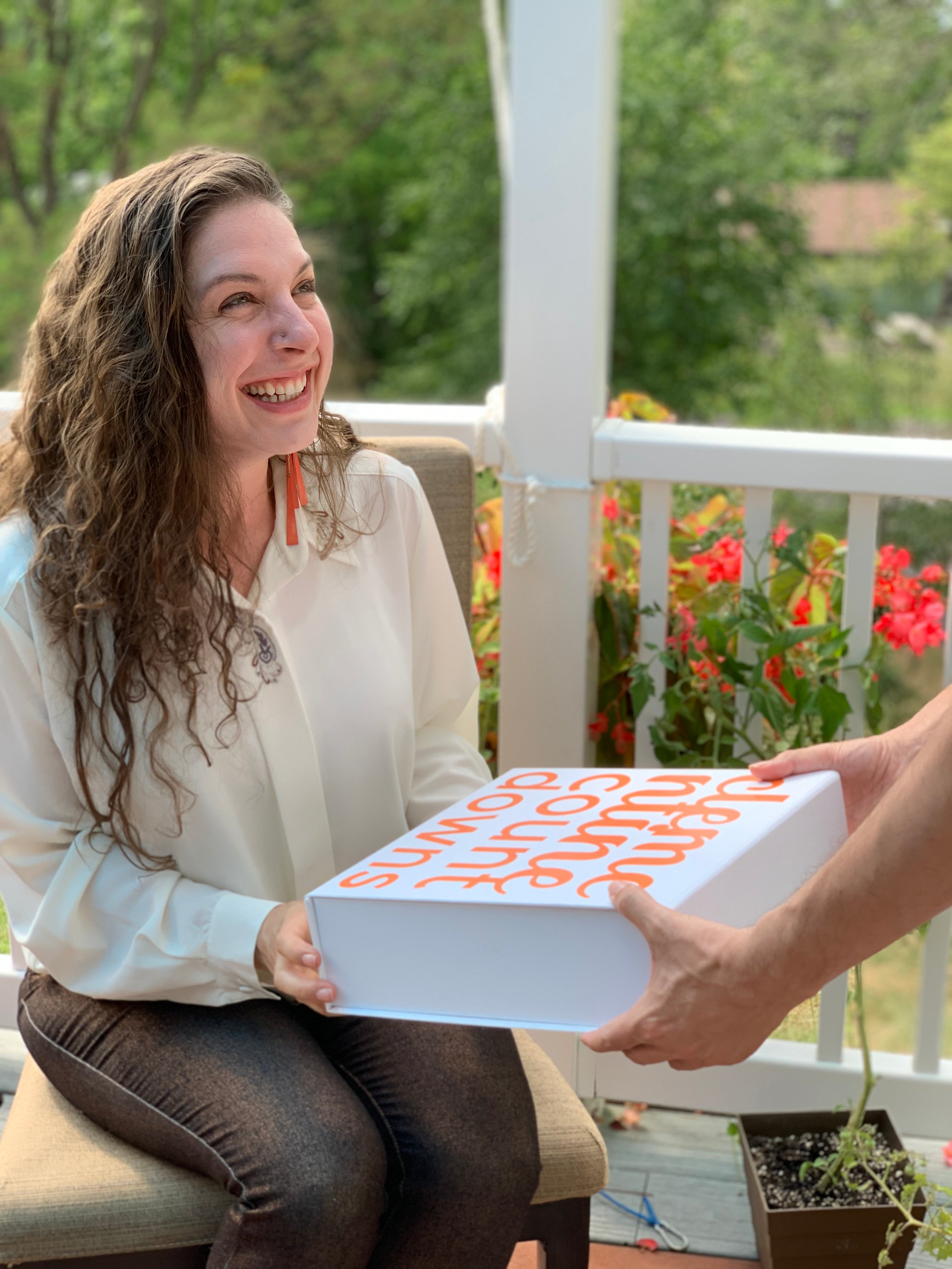 A man hands a gift box experience to a woman